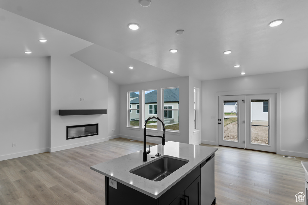 Kitchen with a sink, a healthy amount of sunlight, dishwasher, and open floor plan