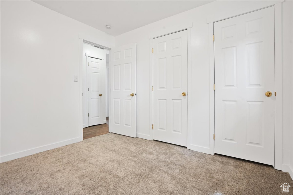 Unfurnished bedroom with baseboards and carpet flooring