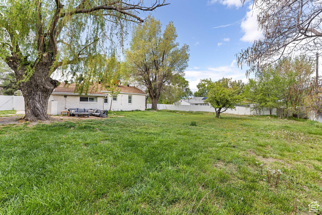 View of yard with a fenced backyard and a patio
