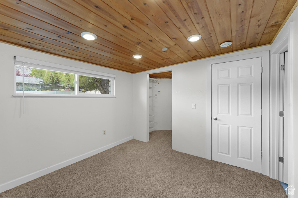 Unfurnished bedroom with carpet flooring, recessed lighting, baseboards, and wooden ceiling