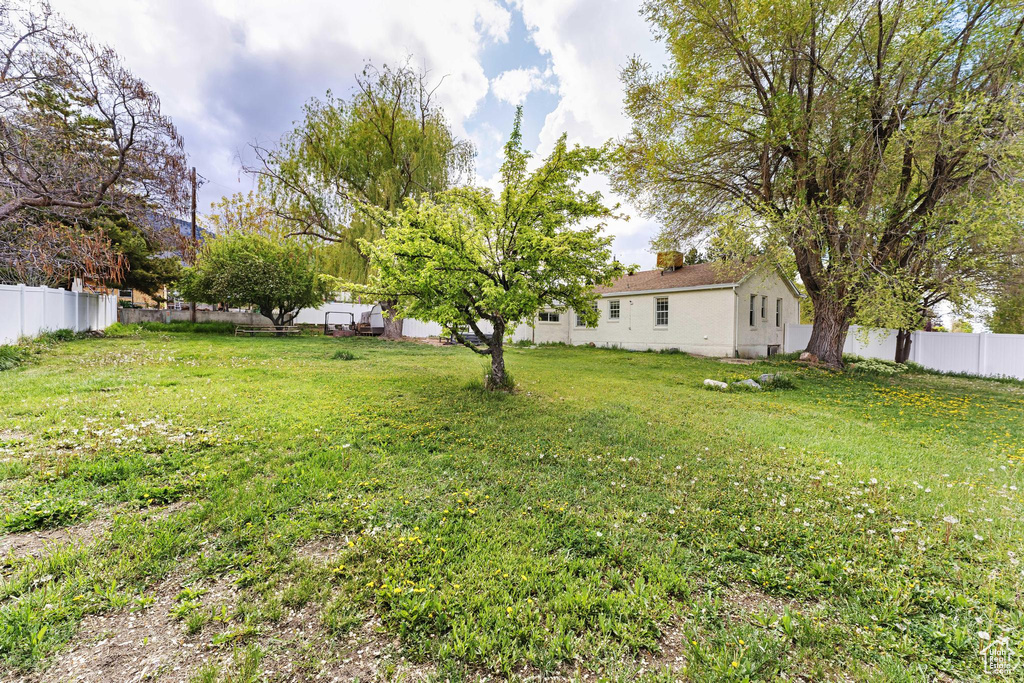 View of yard featuring fence