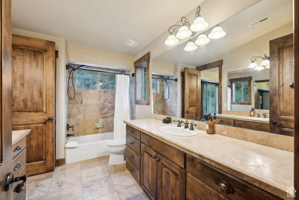 Bathroom with visible vents, tile patterned flooring, shower / tub combo, vanity, and toilet