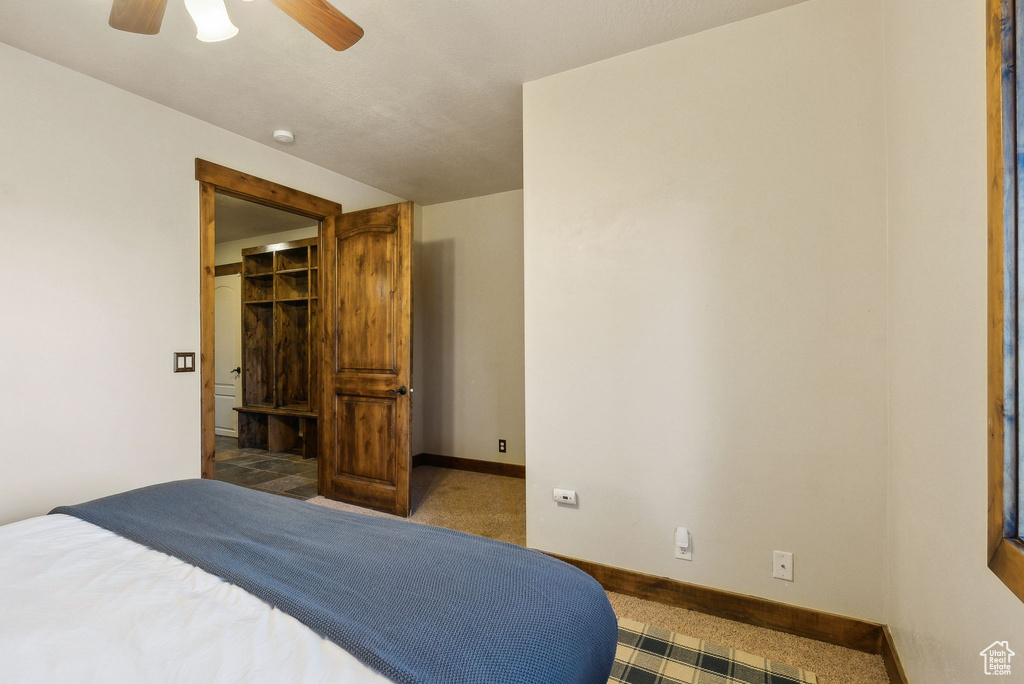 Bedroom featuring carpet floors, a ceiling fan, and baseboards