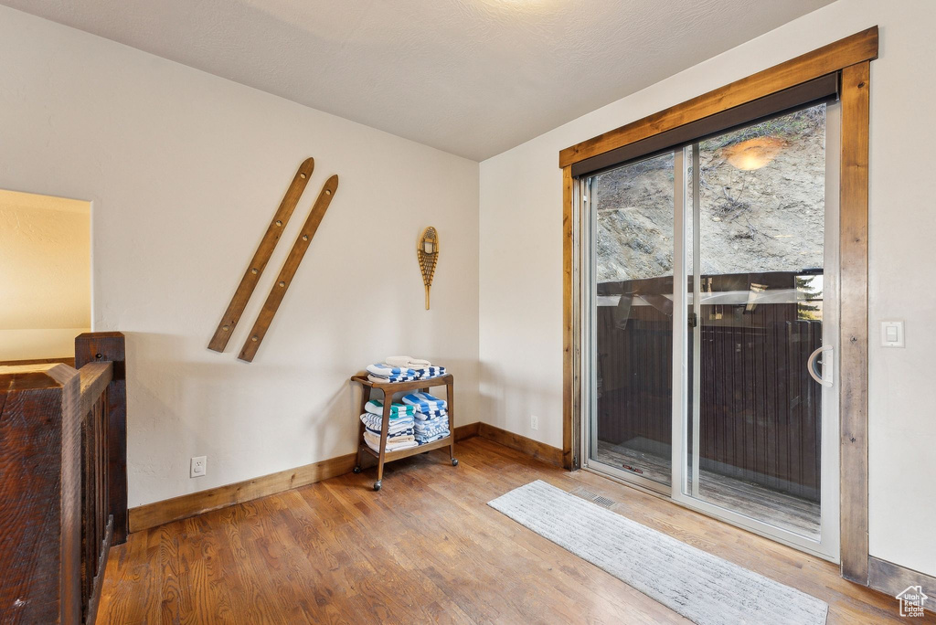 Sitting room with baseboards and wood finished floors
