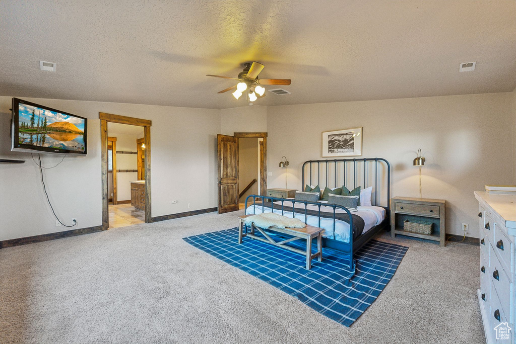 Carpeted bedroom with baseboards and visible vents