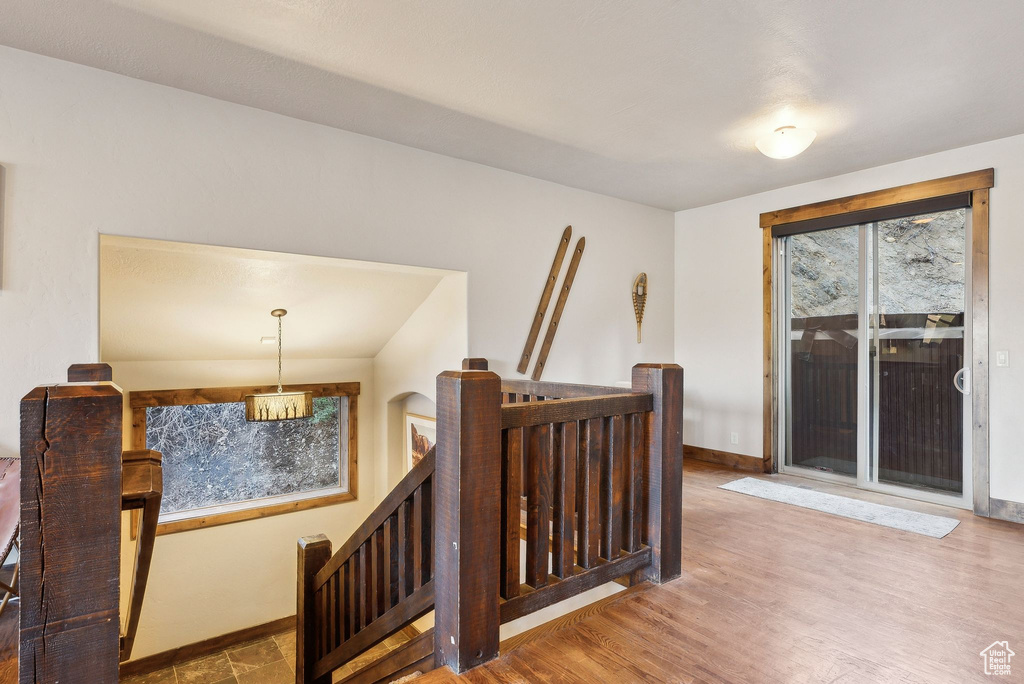 Staircase featuring baseboards and wood finished floors