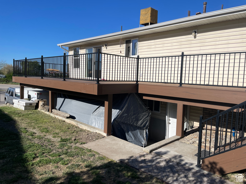 Back of property featuring a wooden deck
