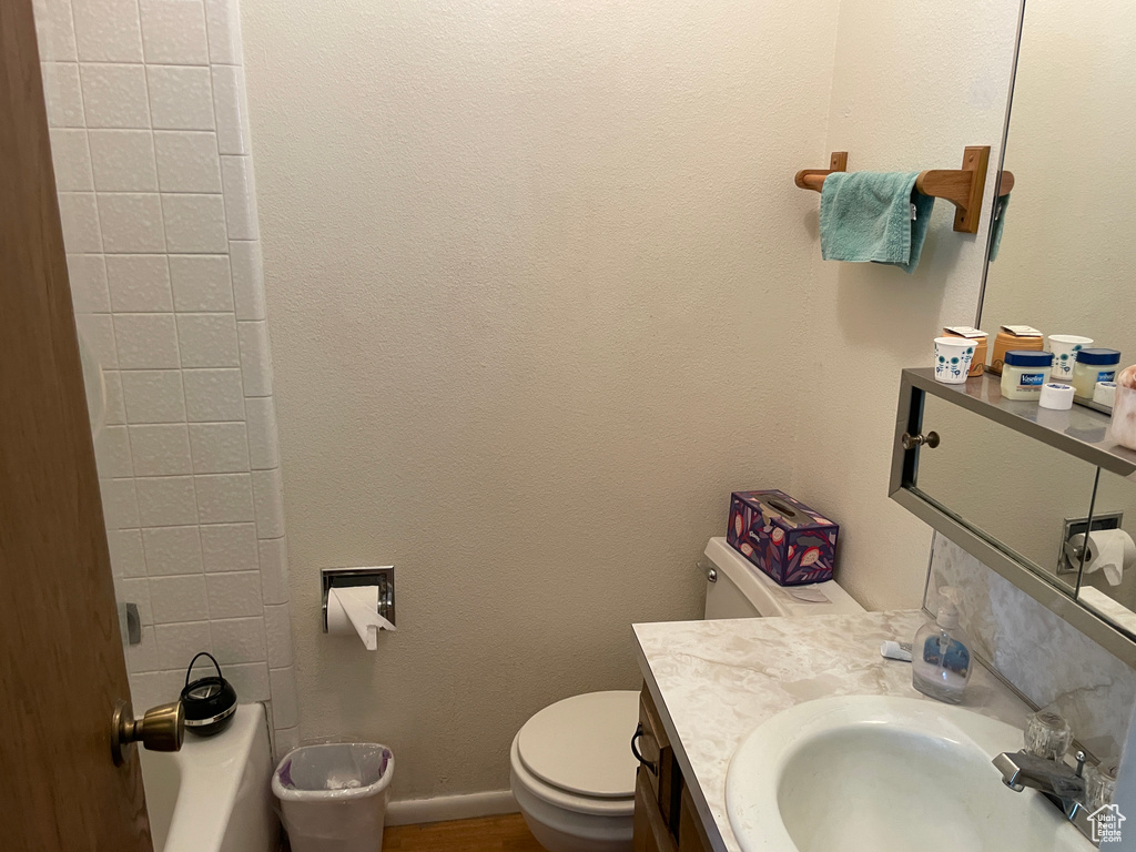 Bathroom with vanity, baseboards, and toilet