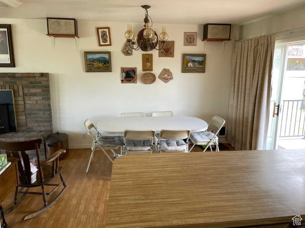 Dining space featuring an inviting chandelier, baseboards, and wood finished floors