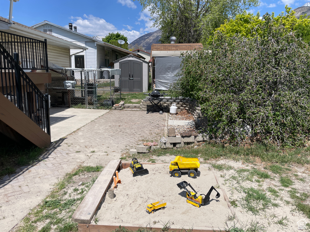 View of yard featuring a storage shed, an outbuilding, and a mountain view