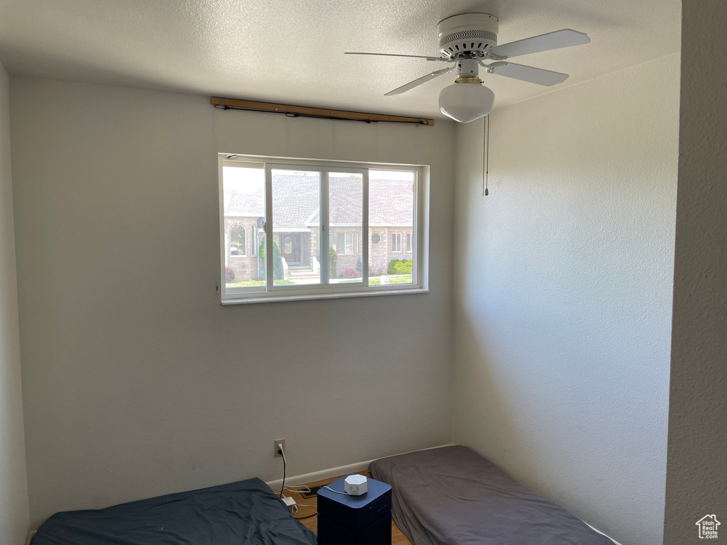 Bedroom with a ceiling fan and baseboards