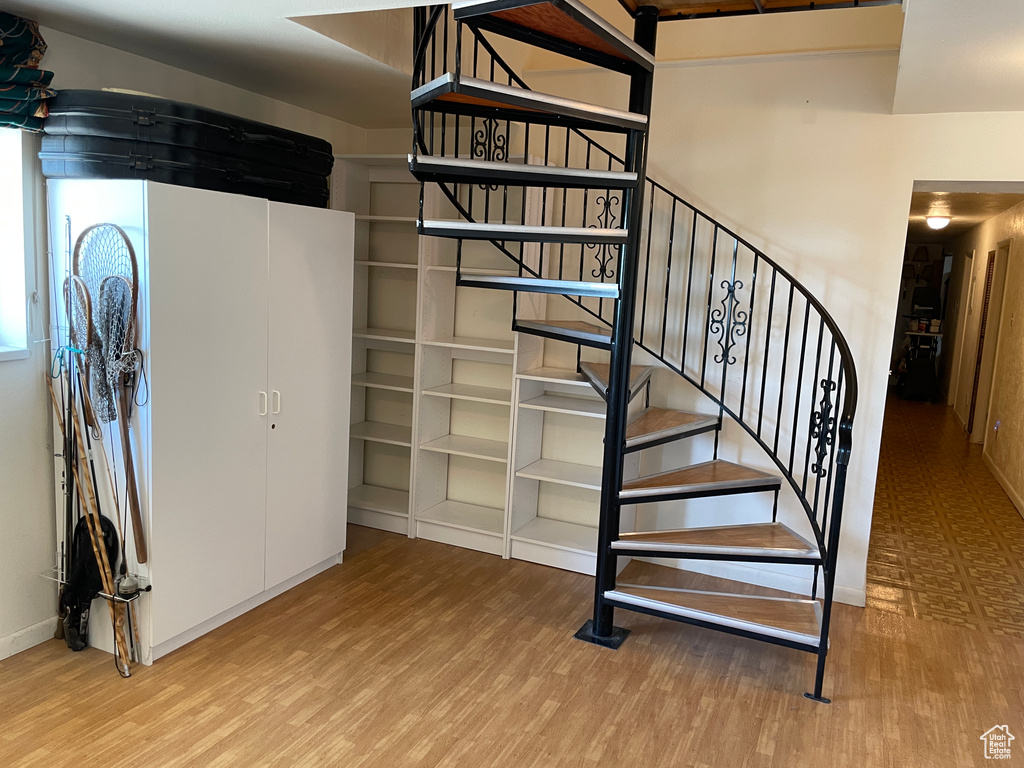 Stairs with baseboards and wood finished floors