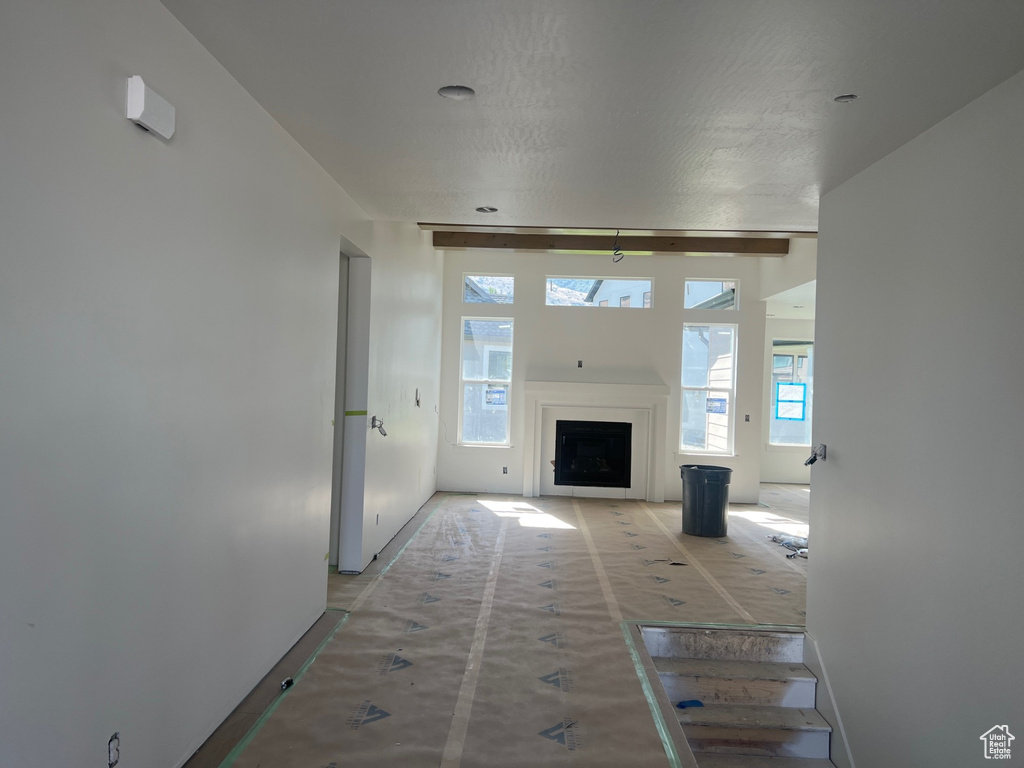 Unfurnished living room with baseboards and a fireplace