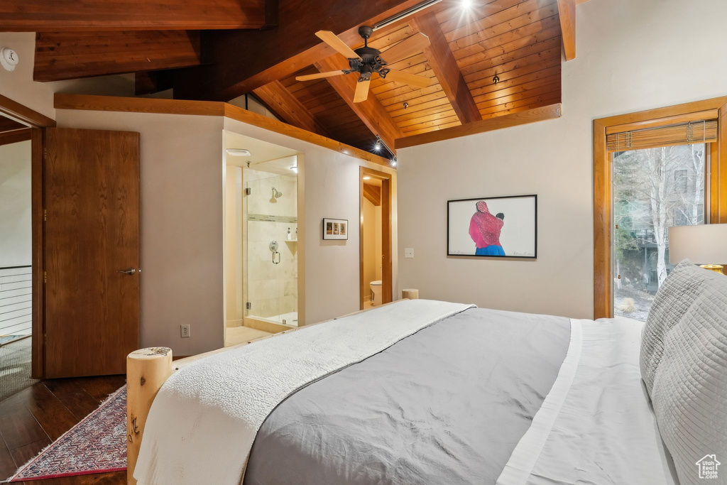 Bedroom featuring wood-type flooring, wooden ceiling, ensuite bath, and lofted ceiling with beams