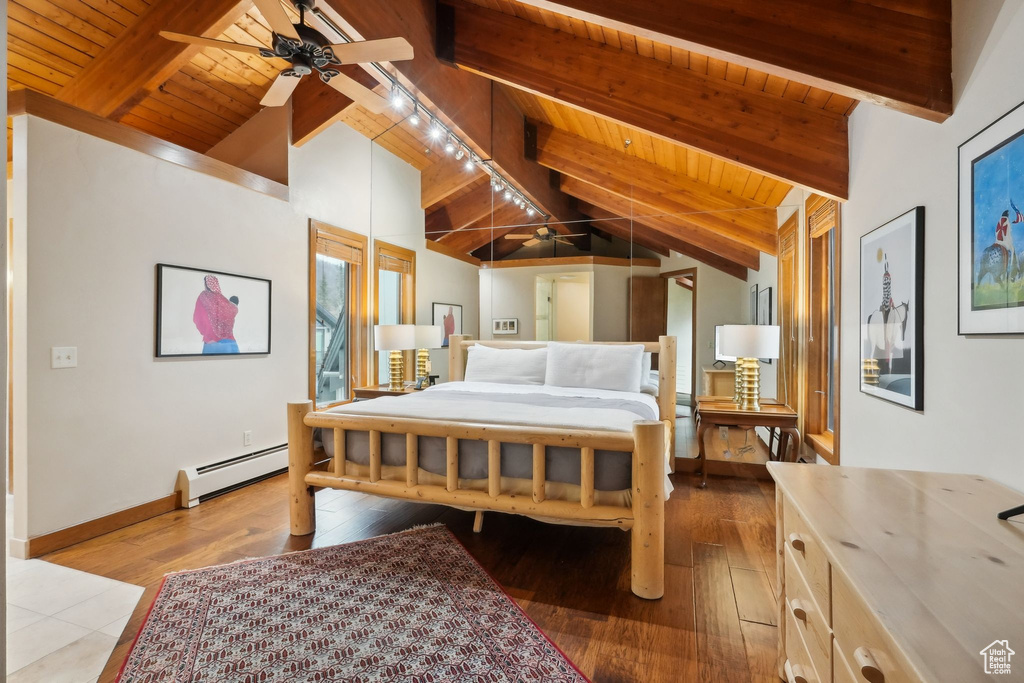 Bedroom featuring hardwood / wood-style floors, a baseboard radiator, vaulted ceiling with beams, and wood ceiling