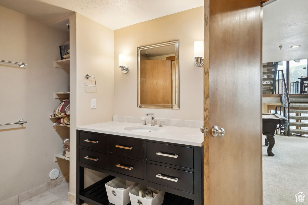 Bathroom with vanity and baseboards