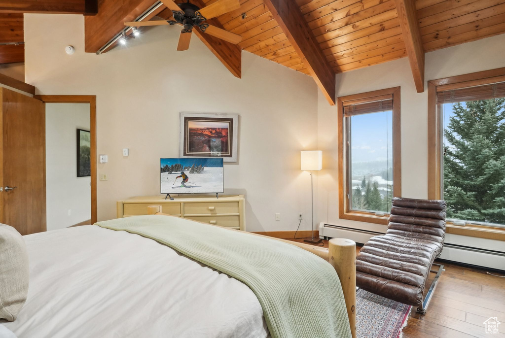 Bedroom featuring wood ceiling, lofted ceiling with beams, and hardwood / wood-style flooring