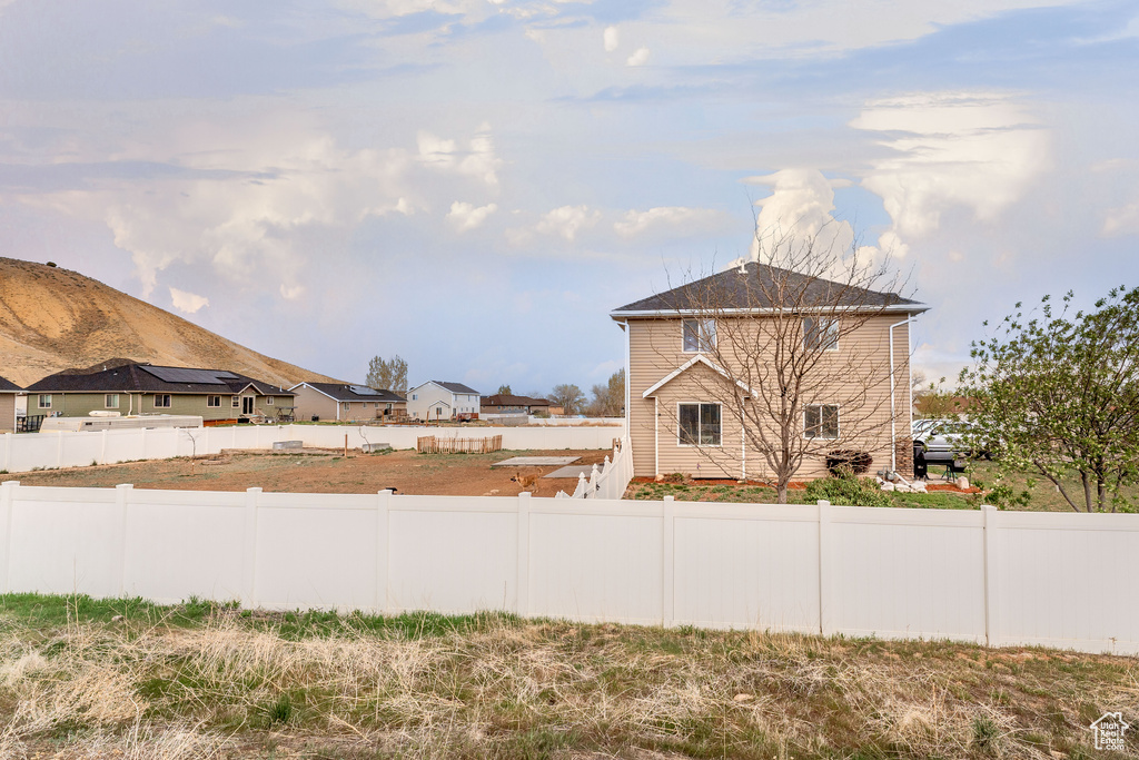 View of yard featuring fence and a mountain view