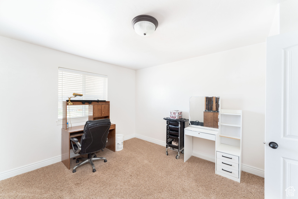 Home office featuring baseboards and light carpet