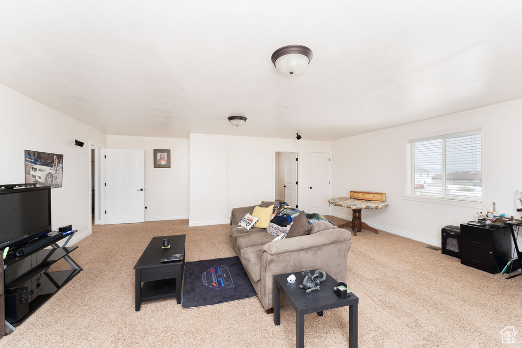 Living room with carpet floors and baseboards