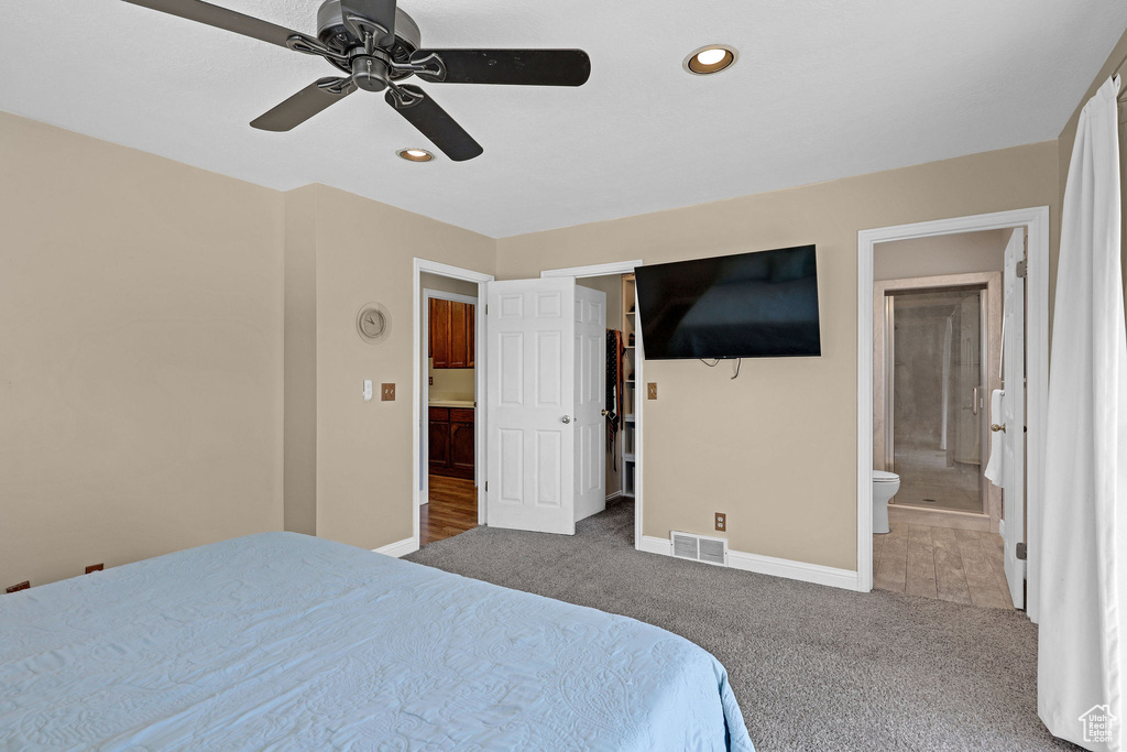 Carpeted bedroom featuring connected bathroom, recessed lighting, baseboards, a spacious closet, and visible vents