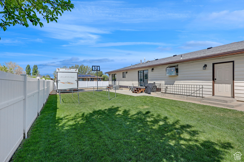 View of yard featuring a patio, a fenced backyard, and entry steps