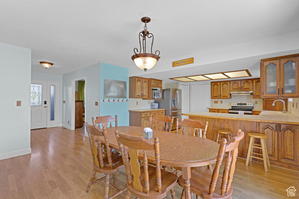Dining room with baseboards and light wood-type flooring