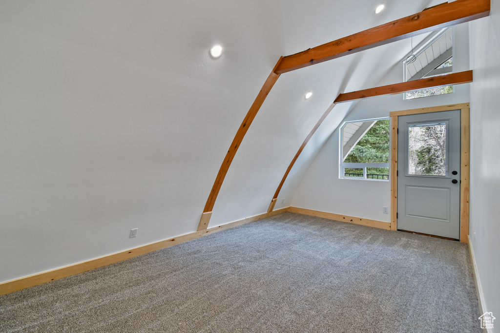 Additional living space with carpet, baseboards, lofted ceiling with beams, and recessed lighting