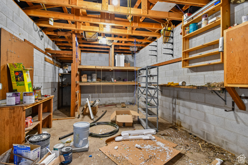 Unfinished basement with concrete block wall