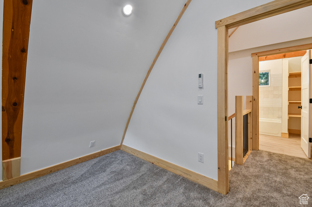 Carpeted spare room featuring baseboards