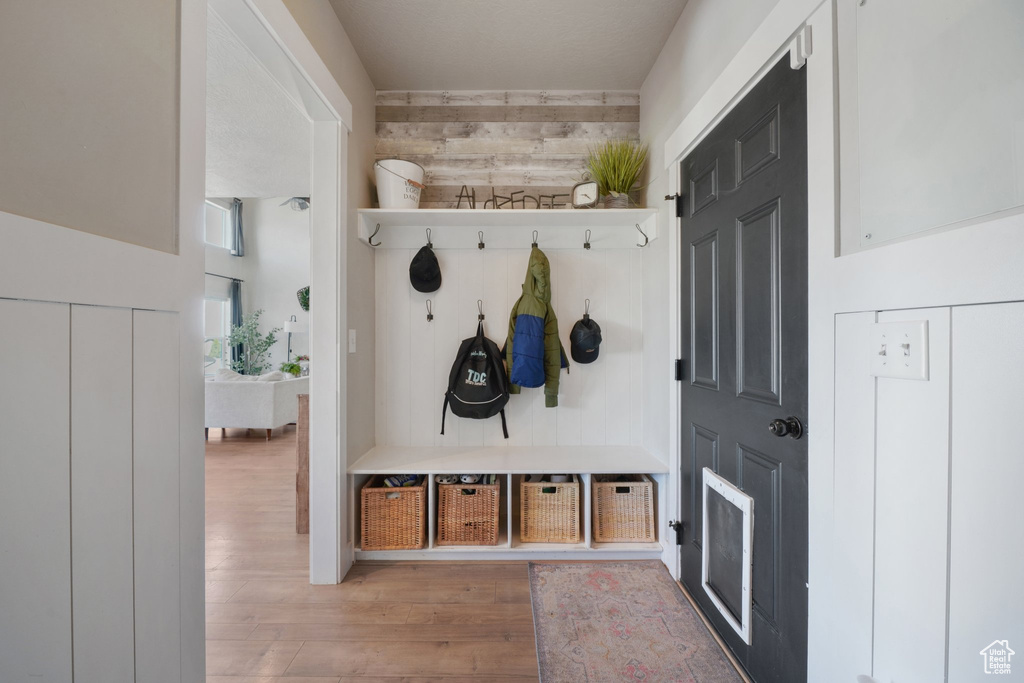 Mudroom with wood finished floors and wooden walls