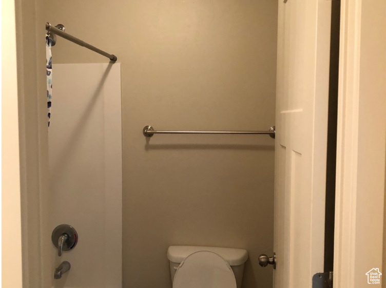 Full bathroom featuring shower / bath combination and toilet