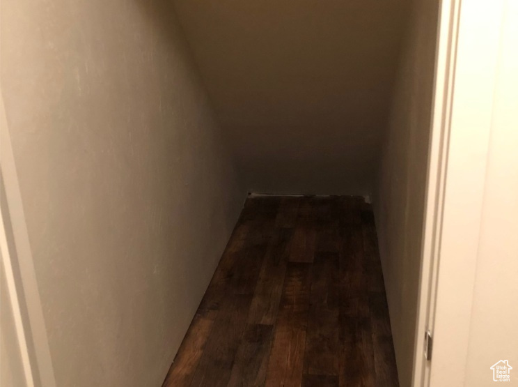 Hallway featuring dark wood finished floors