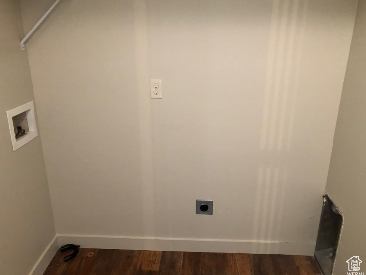 Clothes washing area with washer hookup, hookup for an electric dryer, laundry area, baseboards, and dark wood-style floors