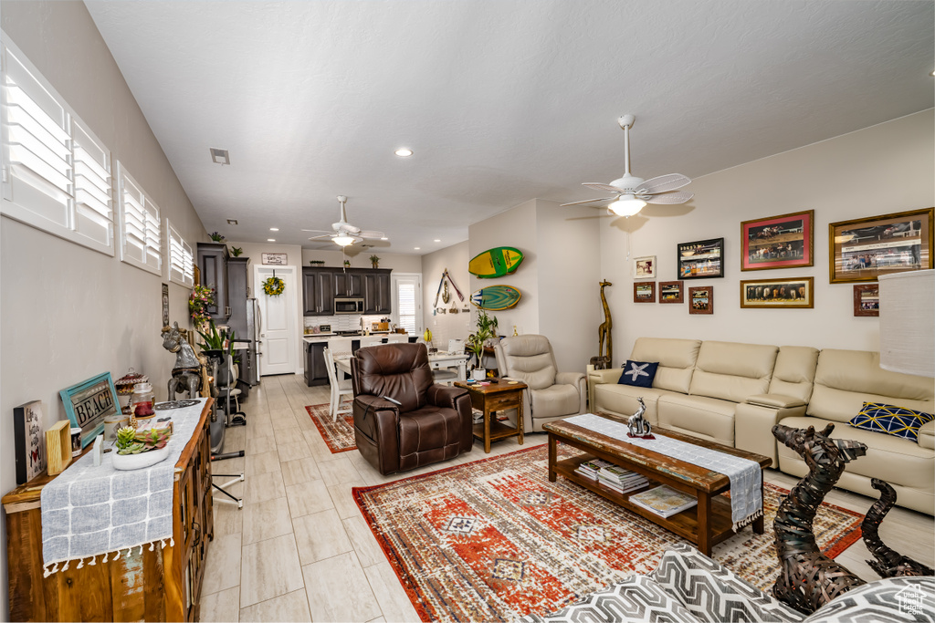 Living room featuring ceiling fan and recessed lighting