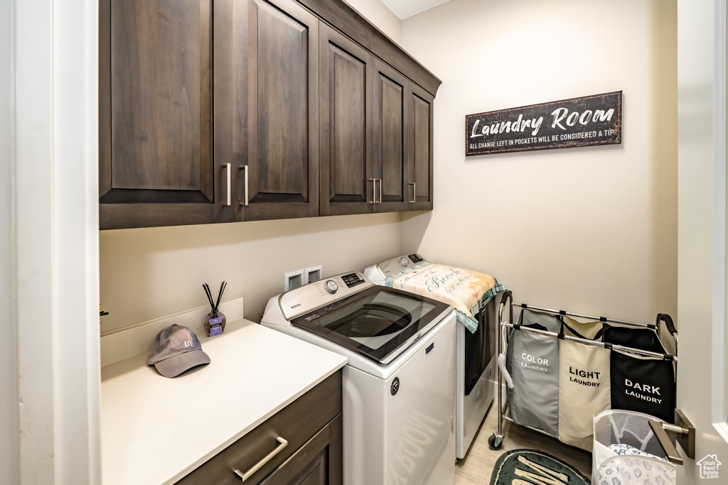Laundry area featuring cabinet space and independent washer and dryer