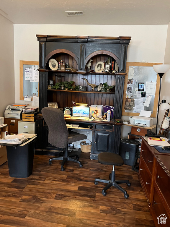 Office space featuring visible vents and wood finished floors