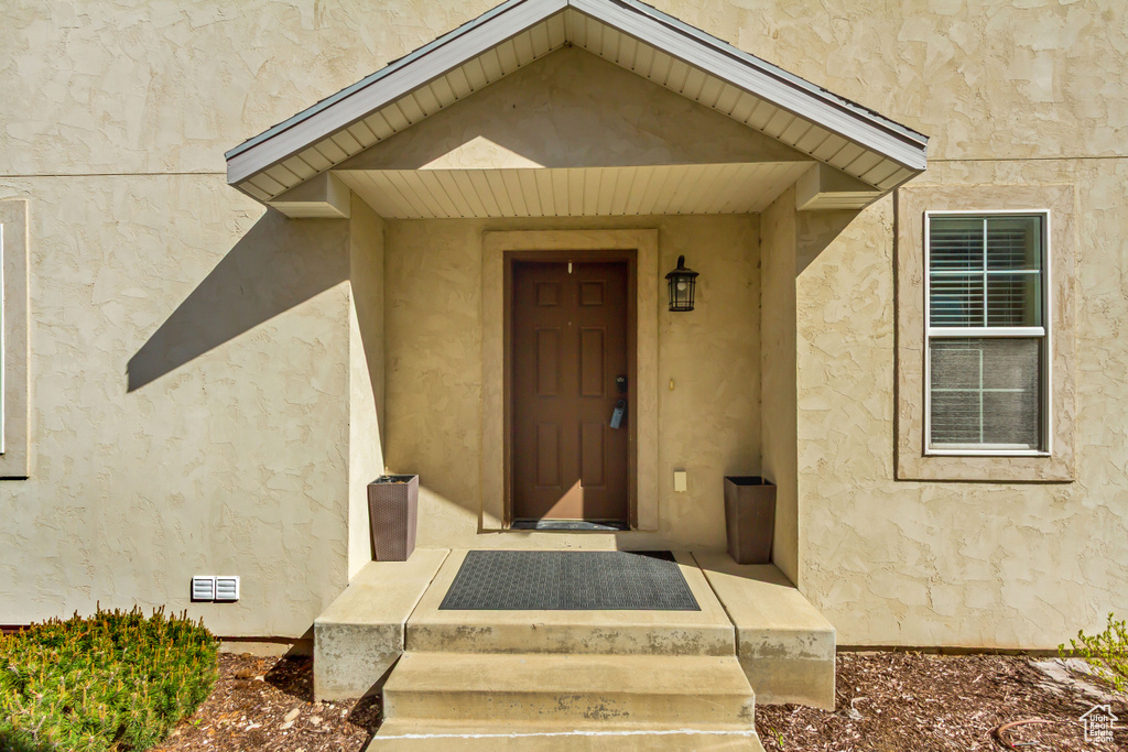 Entrance to property featuring stucco siding