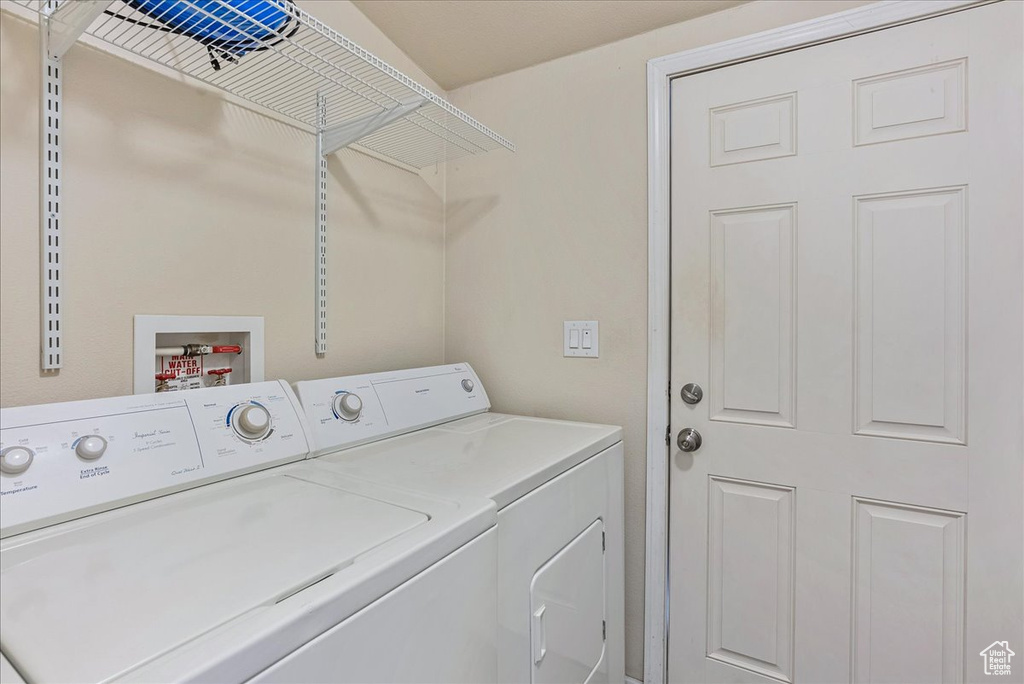 Washroom featuring laundry area and washing machine and dryer