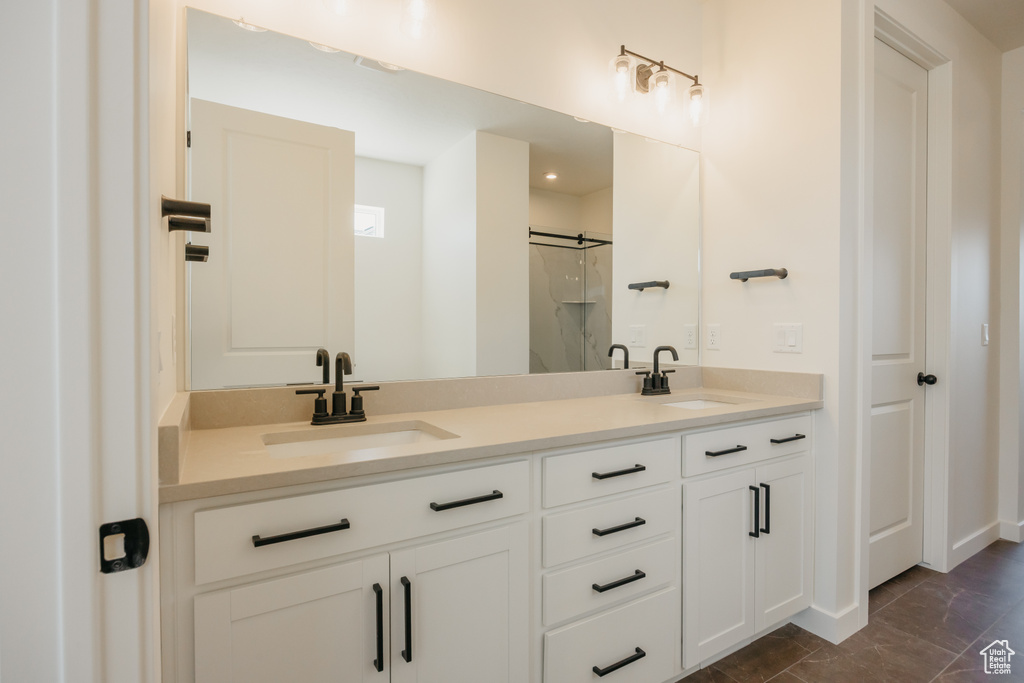 Full bathroom with double vanity and a shower