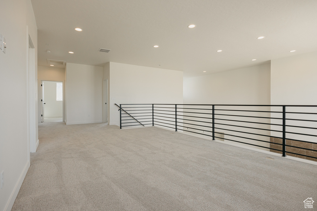 Carpeted spare room featuring recessed lighting and baseboards