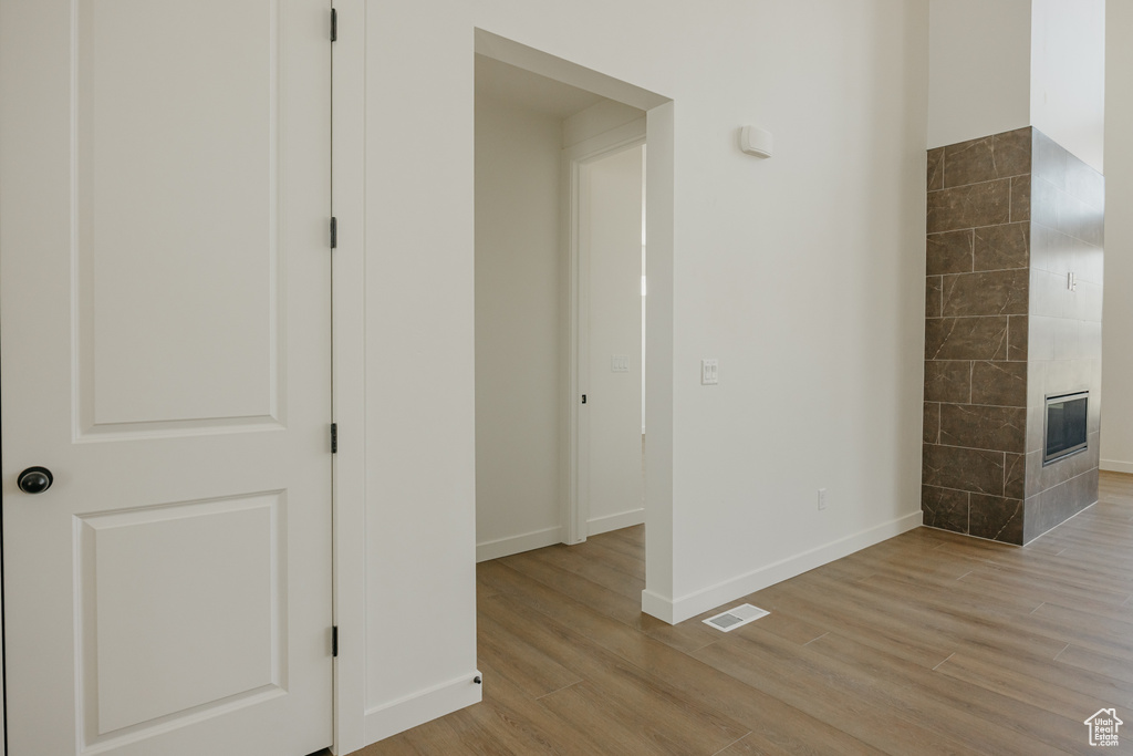Hallway featuring light wood-style floors and baseboards