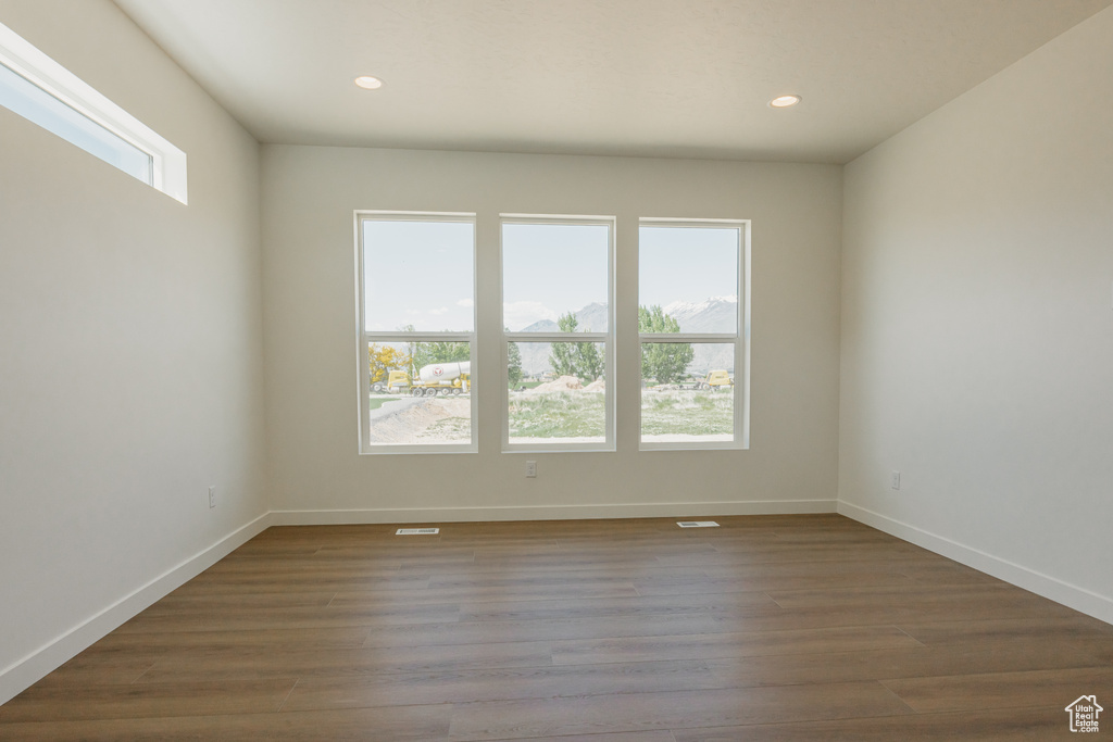 Unfurnished room with recessed lighting, baseboards, and wood finished floors