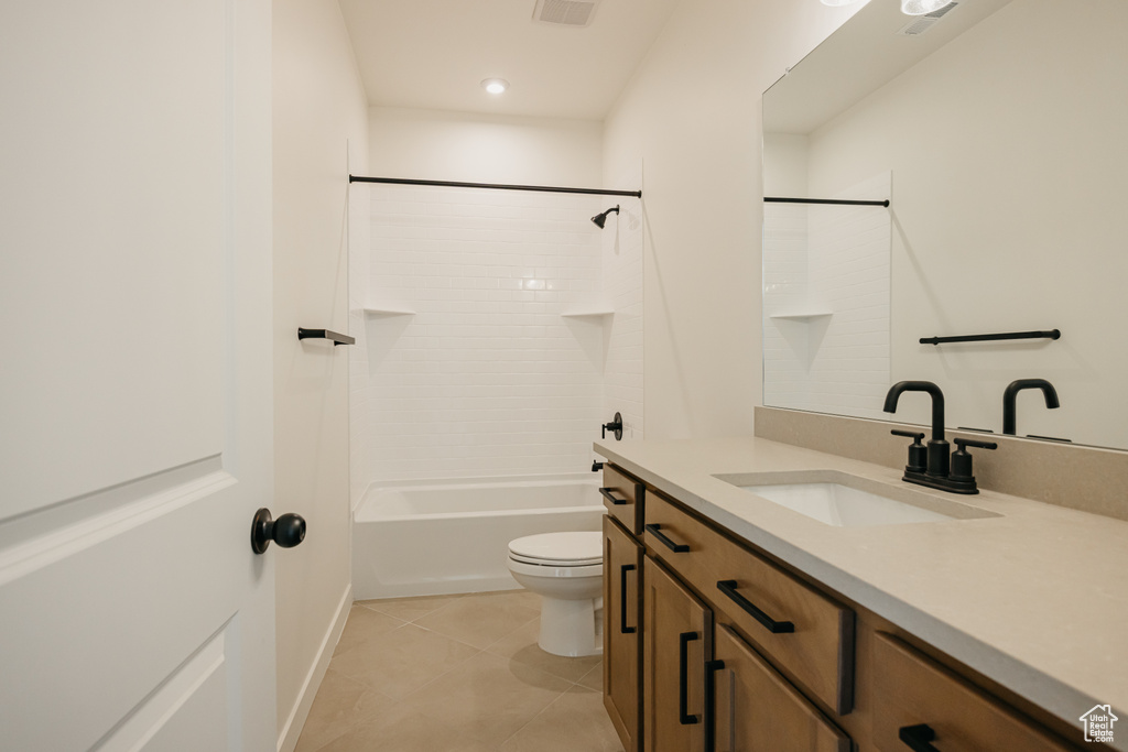 Bathroom with toilet, vanity, tile patterned flooring, recessed lighting, and shower / tub combination