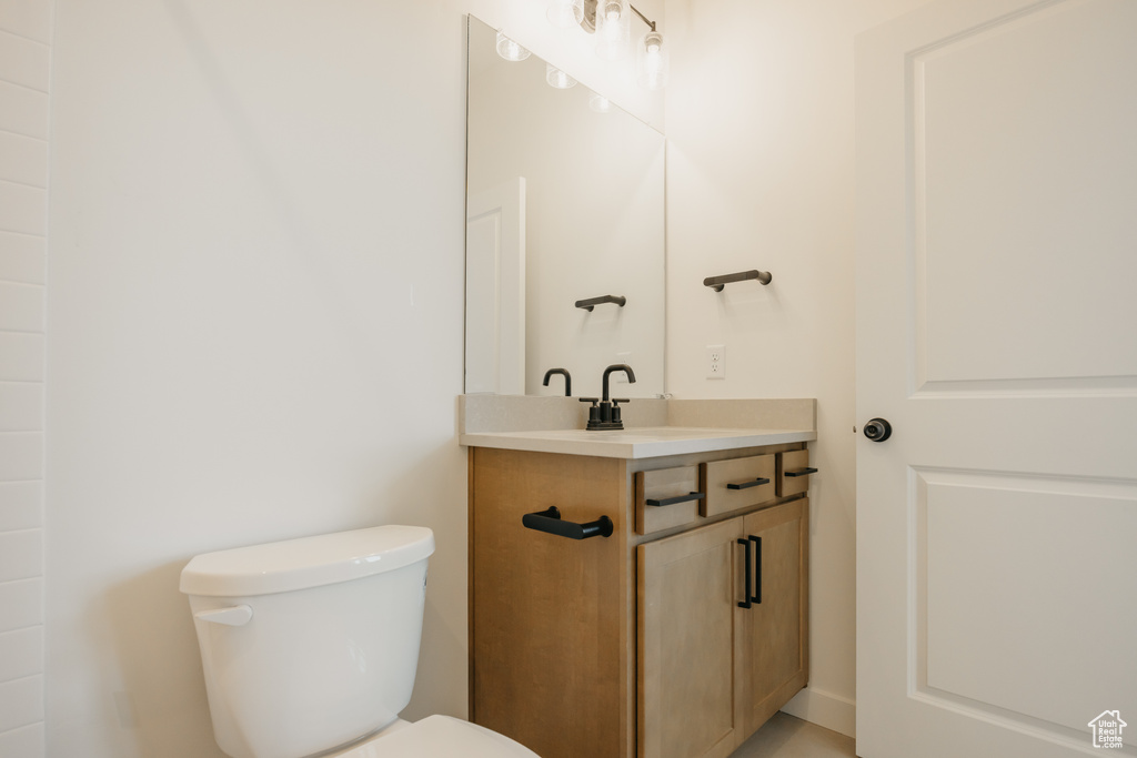 Half bath featuring vanity and toilet