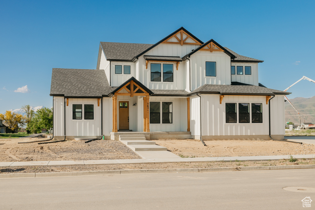 Modern farmhouse with a shingled roof and board and batten siding
