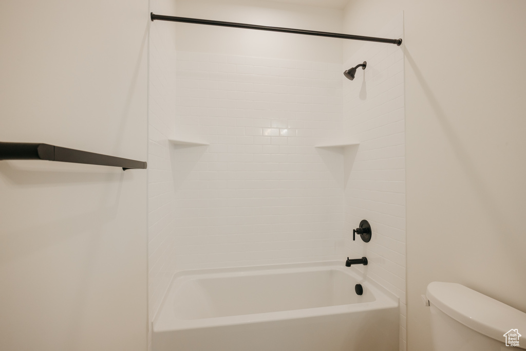 Bathroom featuring toilet and shower / bathtub combination