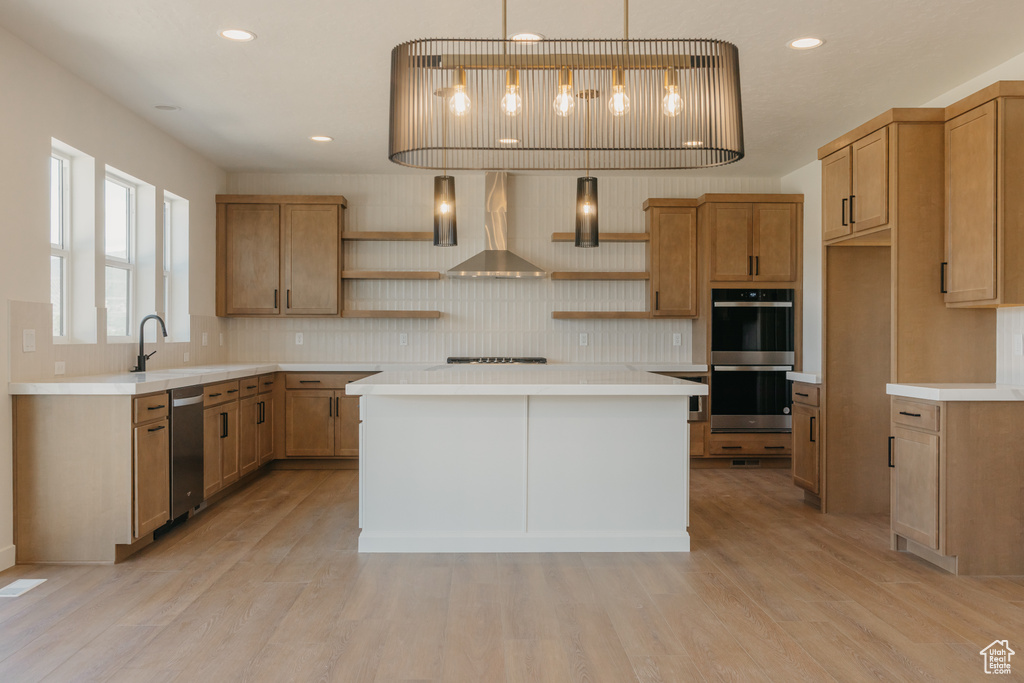 Kitchen featuring open shelves, wall chimney range hood, appliances with stainless steel finishes, tasteful backsplash, and light countertops