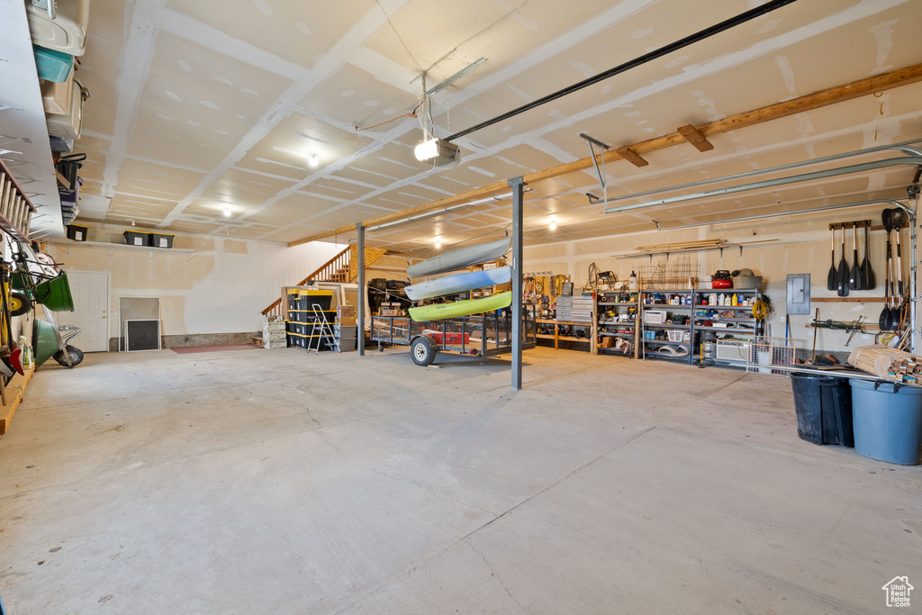 Garage with a garage door opener and a workshop area