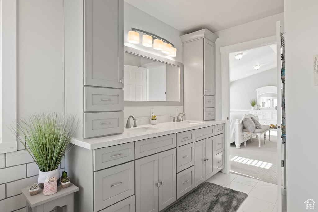 Full bathroom featuring double vanity and a sink
